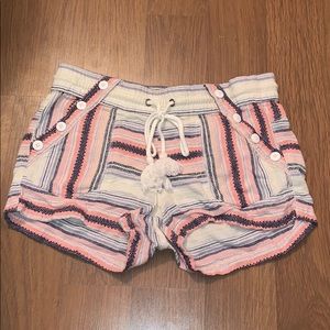Patterned shorts with button accents.